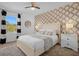 Bedroom with patterned wallpaper and a comfortable double bed at 1041 Las Fuentes Dr, Kissimmee, FL 34746