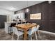 Dining area with a rustic wooden table and white chairs at 1041 Las Fuentes Dr, Kissimmee, FL 34746