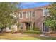 Two-story townhome with a charming front entrance and well-manicured landscaping at 1041 Las Fuentes Dr, Kissimmee, FL 34746