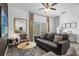 Spacious living room featuring a comfortable couch and large TV at 1041 Las Fuentes Dr, Kissimmee, FL 34746