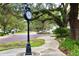 Charming town square featuring a vintage clock tower, brick-paved street, and lush greenery creating a welcoming atmosphere at 1112 Sarah Mathews Dr, Oakland, FL 34787