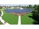 Scenic pond view with a wooden pier, water fountain, and lush green surroundings ideal for relaxation and community enjoyment at 1112 Sarah Mathews Dr, Oakland, FL 34787