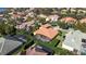 Aerial view of home with pool and lush landscaping near lake at 1519 Lake Rhea Dr, Windermere, FL 34786