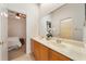 Double vanity bathroom with a large mirror and updated fixtures at 1519 Lake Rhea Dr, Windermere, FL 34786