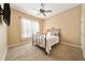 Charming bedroom featuring a metal framed bed and large window at 1519 Lake Rhea Dr, Windermere, FL 34786