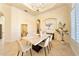 Formal dining room with marble table and chandelier, bright and airy feel at 1519 Lake Rhea Dr, Windermere, FL 34786