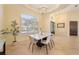 Bright and spacious dining area with marble table and chandelier at 1519 Lake Rhea Dr, Windermere, FL 34786