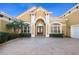 Elegant two-story home with arched entryway and paver driveway at 1519 Lake Rhea Dr, Windermere, FL 34786