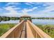 Scenic walkway to gazebo over tranquil lake at 1519 Lake Rhea Dr, Windermere, FL 34786