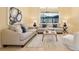 Comfortable living room with neutral colored sofas and large window at 1519 Lake Rhea Dr, Windermere, FL 34786
