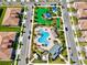 Aerial view of community pool, playground, and homes at 1582 Moon Valley Dr, Champions Gate, FL 33896