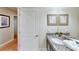 Bathroom with granite vanity, single sink, and framed mirror at 1582 Moon Valley Dr, Champions Gate, FL 33896