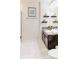 Bathroom with dark vanity, granite countertop, and tile flooring at 1582 Moon Valley Dr, Champions Gate, FL 33896
