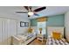 Guest bedroom with two twin beds, ceiling fan, and window treatments at 1582 Moon Valley Dr, Champions Gate, FL 33896