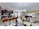 Open kitchen features granite countertops, stainless steel appliances, and an island with seating at 1582 Moon Valley Dr, Champions Gate, FL 33896