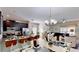 Open concept kitchen and dining area with granite counters and modern lighting at 1582 Moon Valley Dr, Champions Gate, FL 33896
