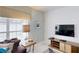 Living area with TV and geometric wall decor at 1582 Moon Valley Dr, Champions Gate, FL 33896