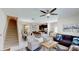 Spacious living room with comfortable seating and view into the kitchen and dining area at 1582 Moon Valley Dr, Champions Gate, FL 33896