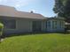 Spacious backyard with grassy lawn and sliding glass doors leading to the house at 1902 Abbington St # 1902, Apopka, FL 32712