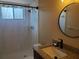 Bathroom with granite countertop, shower, and window at 1902 Abbington St # 1902, Apopka, FL 32712