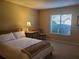 Bright bedroom with a double bed, nightstand, and window at 1902 Abbington St # 1902, Apopka, FL 32712