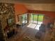 High-ceiling living room with stone fireplace and backyard view at 1902 Abbington St # 1902, Apopka, FL 32712