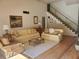Spacious living room with two light beige couches and wood floors at 1902 Abbington St # 1902, Apopka, FL 32712