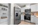 Modern kitchen with stainless steel appliances and ample cabinet space at 1960 Tamarack Pass, Davenport, FL 33837