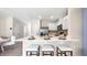 Eat-in kitchen island with seating and white shaker cabinets at 1960 Tamarack Pass, Davenport, FL 33837