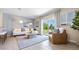 Living room boasts a comfy sofa, natural light, and patio access at 1960 Tamarack Pass, Davenport, FL 33837