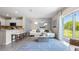 Open concept living room with patio access and a cozy sitting area at 1960 Tamarack Pass, Davenport, FL 33837