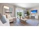 Relaxing living room with large TV, comfy seating, and patio view at 1960 Tamarack Pass, Davenport, FL 33837