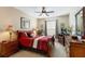 Well-lit bedroom featuring a queen-size bed and wood furniture at 2302 Butterfly Palm Way # 102, Kissimmee, FL 34747