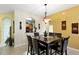Dining area with a dark wood table and six black chairs at 2302 Butterfly Palm Way # 102, Kissimmee, FL 34747