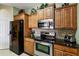 Kitchen boasts modern appliances and dark wood cabinets at 2302 Butterfly Palm Way # 102, Kissimmee, FL 34747