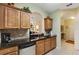 Kitchen with granite countertops, wood cabinets, and modern appliances at 2302 Butterfly Palm Way # 102, Kissimmee, FL 34747