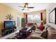 Bright living room with comfortable seating and a flat-screen TV at 2302 Butterfly Palm Way # 102, Kissimmee, FL 34747