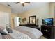 Spacious main bedroom with king-size bed and en-suite bathroom at 2302 Butterfly Palm Way # 102, Kissimmee, FL 34747