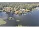 House on a lake with a dock and lush vegetation at 3644 Lake Shore Dr, Apopka, FL 32703