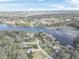 Wide aerial view showing home's location on a lake, surrounded by other houses at 3644 Lake Shore Dr, Apopka, FL 32703