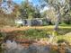 Backyard of home with lake view and lush landscaping at 3644 Lake Shore Dr, Apopka, FL 32703