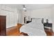 Bright bedroom with hardwood floors, a comfortable bed and built-in cabinets at 3644 Lake Shore Dr, Apopka, FL 32703