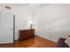 Well-lit bedroom with hardwood floors and dresser at 3644 Lake Shore Dr, Apopka, FL 32703
