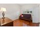 Cozy bedroom with hardwood floors and a futon at 3644 Lake Shore Dr, Apopka, FL 32703