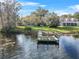 Wooden dock on calm lake next to house at 3644 Lake Shore Dr, Apopka, FL 32703