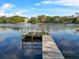 Wooden dock extending over a calm lake at 3644 Lake Shore Dr, Apopka, FL 32703