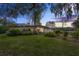 Mid-century home with a two-car garage and landscaped lawn at 3644 Lake Shore Dr, Apopka, FL 32703