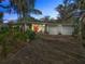 Mid-century home with a two-car garage and stone driveway at 3644 Lake Shore Dr, Apopka, FL 32703