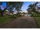 Mid-century home with a two-car garage and stone driveway at 3644 Lake Shore Dr, Apopka, FL 32703