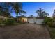 Mid-century home with a two-car garage and stone driveway at 3644 Lake Shore Dr, Apopka, FL 32703
